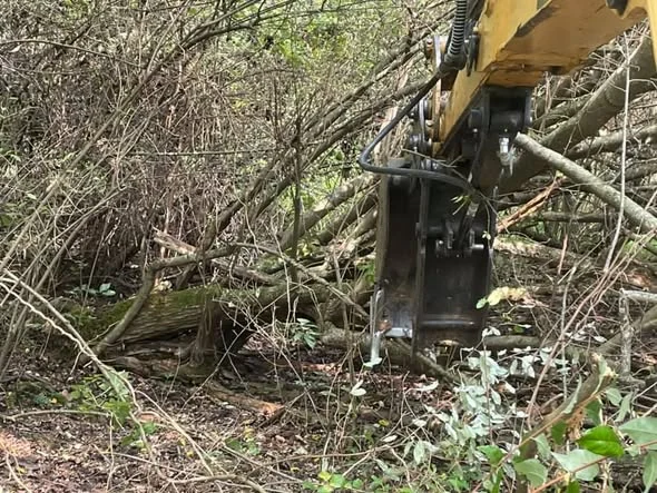 Equipment attachment working through brush